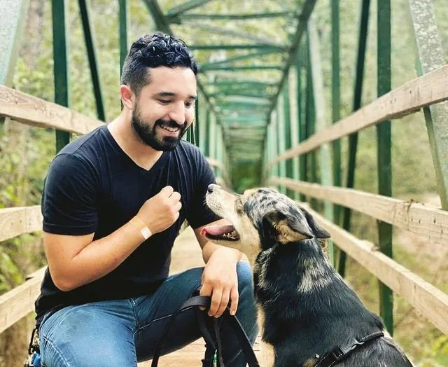 Dog owner rewarding his dog with a treat during in-home dog training in Austin